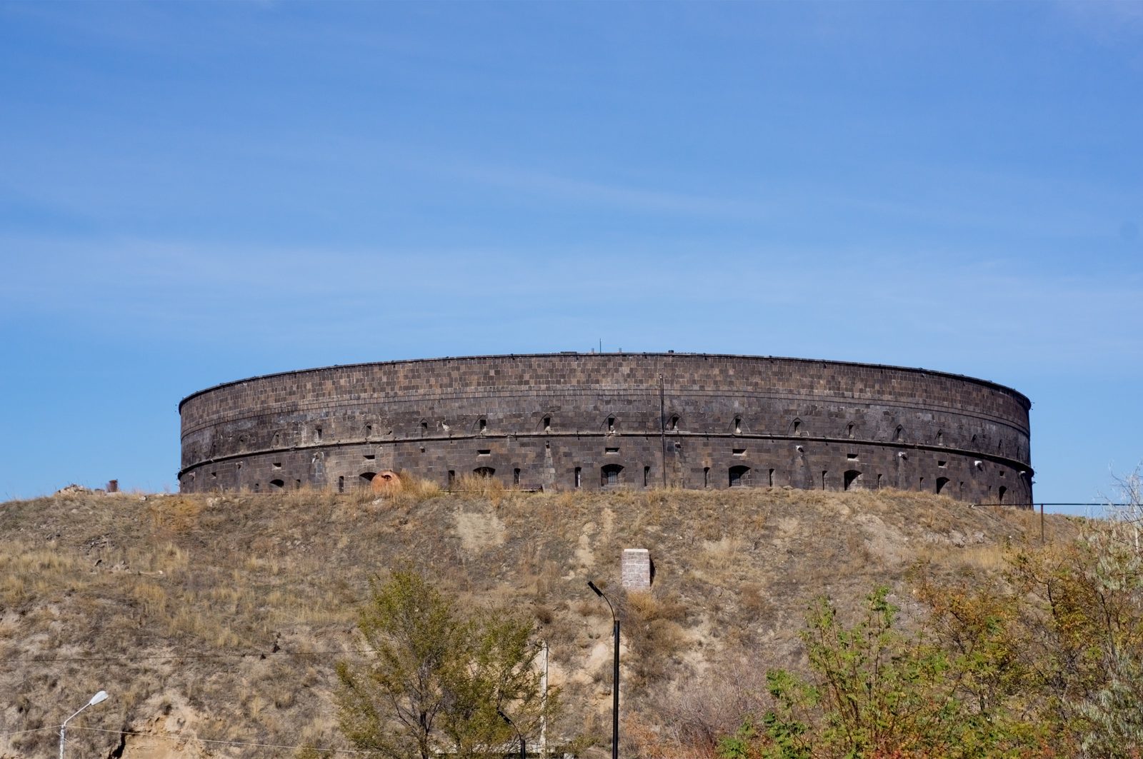 The Black Fortress (Sev Berd) in Gyumri: a ring wall of dark stone on a grassy hill