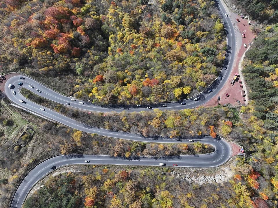 M4 highway winding through autumn forest near Dilijan
